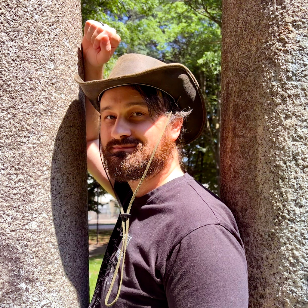 Mattias Cibien in a cowboy hat between two columns
